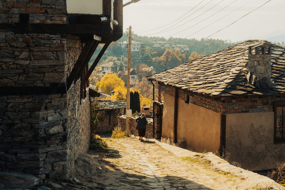Cobbled lane between old stone houses with slate roofs in the Bulgarian village of Leshten