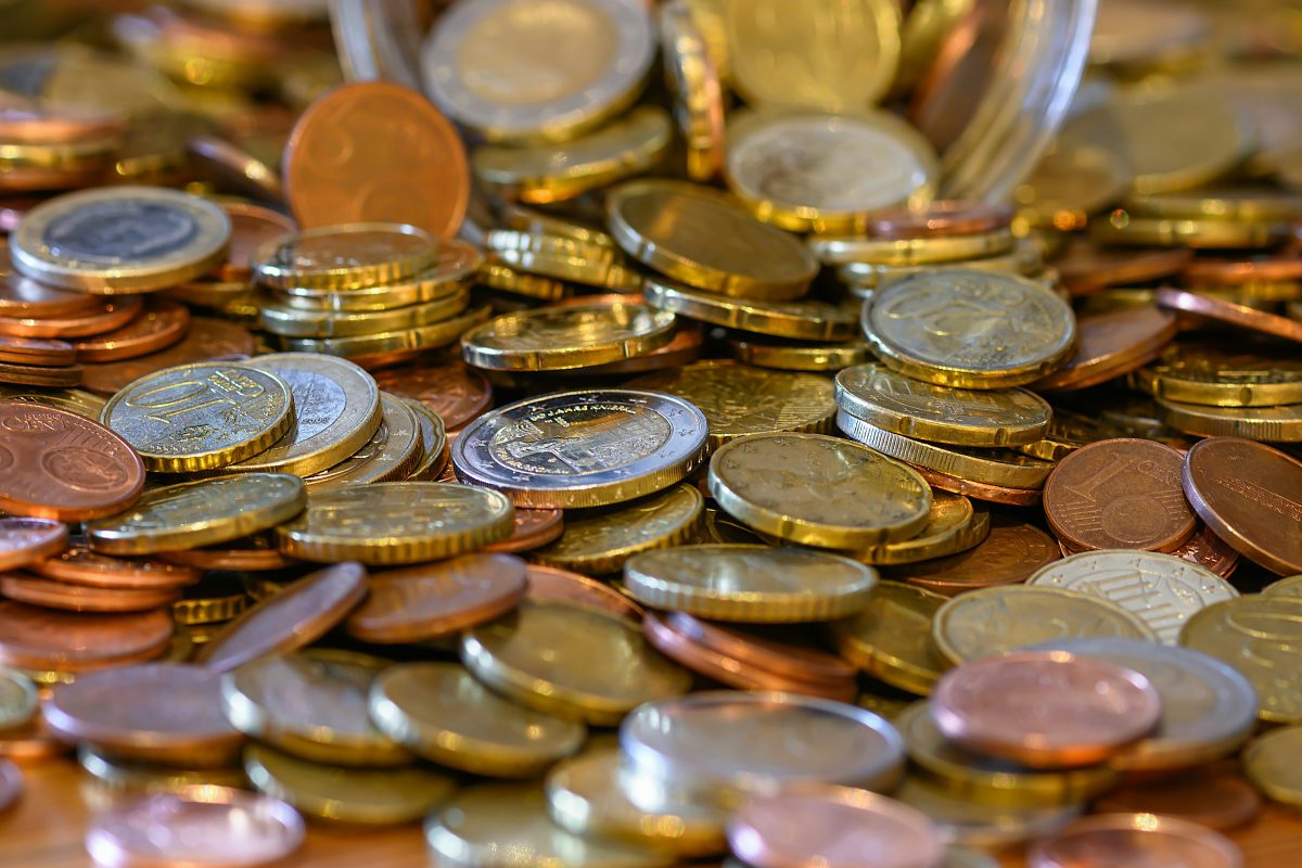Close-up of a pile of euro coins on a wooden table