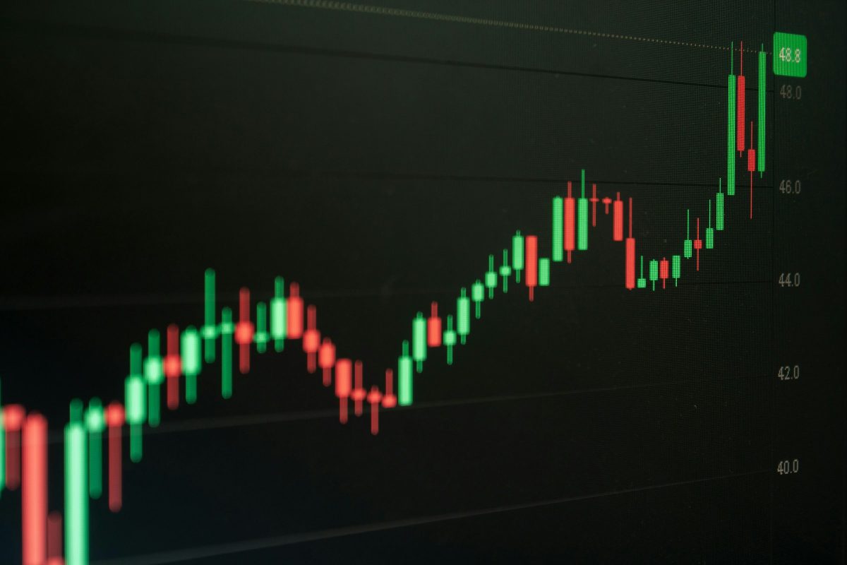 Candlestick chart on a screen showing a rising price trend