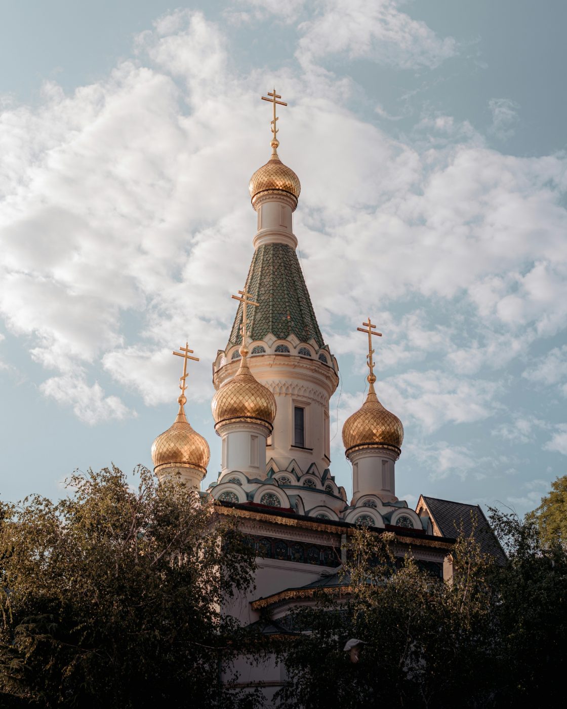 Gilded onion domes and green-tiled spire of the Russian Church of St Nicholas in Sofia